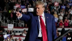 FILE - Republican presidential candidate and former President Donald Trump arrives for a campaign rally in Erie, Pennsylvania, July 29, 2023.