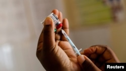 FILE - A nurse fills a syringe with malaria vaccine at the Lumumba Sub-County hospital in Kisumu, Kenya, July 1, 2022. 
