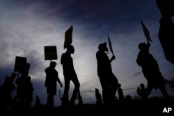 FILE - UPS teamsters and workers hold a rally, July 21, 2023, in Atlanta, Georgia, as a national strike deadline nears.