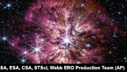 FILE - This image provided by NASA shows the star Wolf-Rayet 124, center, captured by the James Webb Space Telescope in June 2022.