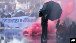 Police use a water cannon during a protest and blockade of a major highway in the downtown area near where it runs past the temporary home of the Dutch parliament, during a climate protest in The Hague, Netherlands, March 11, 2023.