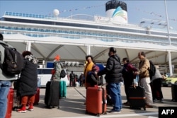 Passengers wait in line to board China's first domestically built cruise ship the Adora Magic City in Shanghai, on Jan. 1, 2024. (AFP)