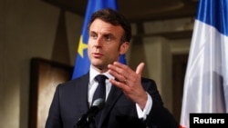 FILE - French President Emmanuel Macron makes a statement during the Munich Security Conference, in Munich, Germany, Feb. 17, 2023. 