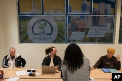 Student ambassadors Andrew Rodriguez, from right, Jaden Hugenberger and Jeff Kaisershot share a light moment at the California Center for Climate Change Education on the West Los Angeles College campus in Culver City, Calif., Tuesday, March 12, 2024. (AP Photo/Jae C. Hong)