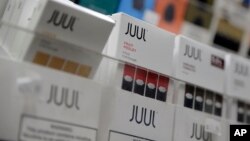 FILE - Juul vaping products are displayed at a smoke shop in New York City, Dec. 20, 2018.