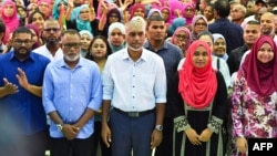 Maldives President-elect Mohamed Muizzu, center, of the People's National Congress (PNC) party delivers a speech during a gathering with supporters following the country's presidential election, in Male on Oct. 2, 2023.