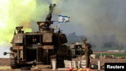 An Israeli artillery unit operates near the border with Gaza, amid the ongoing conflict between Israel and Palestinian Islamist group Hamas, as seen from southern Israel, Dec. 12, 2023. 