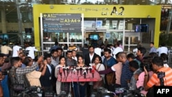 Indian nationals (C), who were stranded in Sudan, speak to the media upon arriving at the domestic terminal of the Chennai International Airport in Chennai on April 27, 2023. 