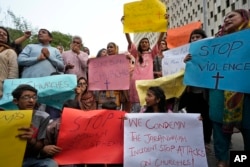 Members of Christian groups and others demonstrate to condemn the attack on a Christian area and a burned church by angry Muslim mob in Karachi, Pakistan, Aug. 16, 2023.