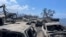 In this photo provided by Tiffany Kidder Winn, burned-out cars sit after a wildfire raged through Lahaina, Hawaii, on Aug. 9, 2023. 