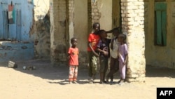 Displaced Sudanese children stand in the courtyard of a school, where their families took refuge, near Gadaref city in war-torn Sudan on March 6, 2024.
