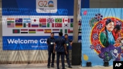 Security officers stand guard at the main venue of the G20 Summit, in New Delhi, Sept. 8, 2023.