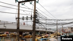 FILE - Electric wires are pictured in Ojuelegba district in Nigeria's commercial capital of Lagos, June 18, 2018. Nigerian authorities announced on April 3, 2024, a nearly 300% increase in electricity rates for some of its consumers.