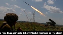 Ukrainian servicemen fire a BM-21 Grad multiple launch rocket system towards Russian positions near the front line in Ukraine's Zaporizhzhia region, June 25, 2023. 