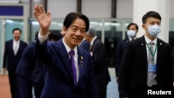 Taiwan’s Vice President William Lai waves inside Taoyuan International Airport following his trip to the United States and Paraguay, in Taoyuan, Taiwan, Aug. 18, 2023.