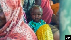 FILE - Sudanese refugees gather outside a field hospital in Acre, Chad, Aug. 15, 2023.