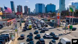 FILE - Commuters wait to drive through the Holland Tunnel into New York City in Jersey City, N.J., March 8, 2023. A study published May 22, 2024, says U.S. vehicles hit a record average age of 12.6 years in 2024.