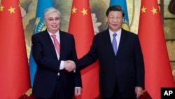 In this photo released by Xinhua News Agency, visiting Kazakhstan's President Kassym-Jomart Tokayev, left, shakes hands with Chinese President Xi Jinping ahead of the China-Central Asia Summit in Xi'an in China's Shaanxi province, May 17, 2023.