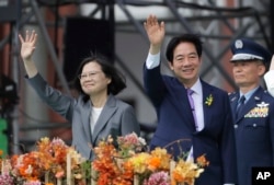 Taiwan's new President Lai Ching-te, right, and former President Tsai Ing-wen wave during Lai's inauguration ceremonies in Taipei, Taiwan, May 20, 2024.