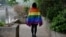 FILE - A gay student sports a rainbow flag in Beijing, May 10, 2019. The Beijing LGBT Center, one of China's leading organizations providing resources and support for the queer population, announced in May 2023 that it would cease operations.