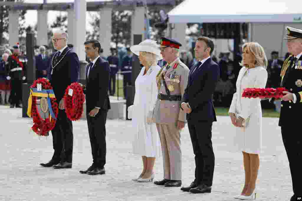Prime Minister of the United Kingdom, Rishi Sunak, second right, Britain's King Charles III and Queen Camilla with French President Emmanuel Macron, 3rd right, his wife Brigitte Macron, 2nd right, attend a commemorative ceremony marking the 80th anniversary of the World War II D-Day" Allied landings in Normandy, at the World War II British Normandy Memorial of Ver-sur-Mer, June 6, 2024.