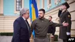 This handout picture taken and released by Ukrainian Presidential press service on March 8, 2023 shows Ukrainian President Volodymyr Zelensky (R) welcoming Secretary-General of the United Nations António Guterres (L) prior to their meeting in Kyiv.