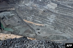 FILE - A general view of haul trucks carrying ore of the open pit of the Jwaneng Diamond Mine in Jwaneng, Botswana, May 11, 2023.