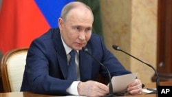 Russian President Vladimir Putin speaks during a meeting with Cabinet members in Moscow, May 6, 2024. Putin thanked Cabinet ministers for their work ahead of his inauguration on May 7, 2024. 