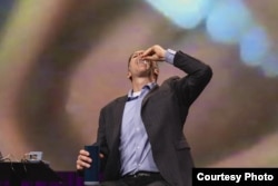 Alex Luebke swallows a PillBot at the 2024 TED Conference in Vancouver, British Columbia. (Jason Redmond/TED)