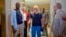 Released hostages French journalist Olivier Dubois, left, and American aid worker Jeffery Woodke, center, arrive at the VIP lounge at the airport in Niamey, Niger, March 20, 2023.
