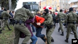 FILE - Police officers detain protesters during a rally in support of Maria Kolesnikova, a member of the Coordination Council created by the opposition to facilitate talks with Lukashenko, in Minsk, Belarus, on Sept. 8, 2020.