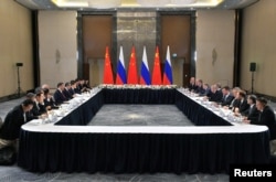 Members of the delegations, led by Russian President Vladimir Putin and Chinese President Xi Jinping, hold talks on the sidelines of the Shanghai Cooperation Organization summit in Astana, Kazakhstan, on July 3, 2024. (Sputnik via Reuters)