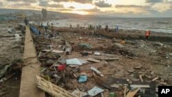 FILE - Rescuers and relatives search for bodies of the flood victims in Derna, Libya, Sept. 15, 2023.