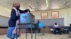 FILE - A woman casts her ballot at Moshupa village, in the Southern District of Botswana, Oct. 23, 2019. While women make up more than 50% of voters, the majority of candidates in the country’s 2024 general elections are male.