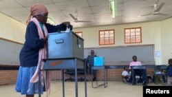 FILE - A woman casts her ballot at Moshupa village, in the Southern District of Botswana, Oct. 23, 2019. While women make up more than 50% of voters, the majority of candidates in the country’s 2024 general elections are male.