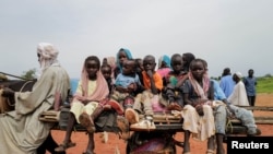 FILE - Sudanese children who fled the conflict in Murnei in Sudan's Darfur region ride a cart while crossing the border between Sudan and Chad in Adre, Chad, Aug. 4, 2023.
