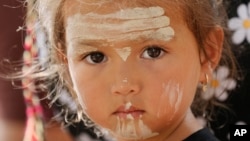 Elouera Dephoff, 2, has traditional paint adornments on her face while attending an Indigenous Australians protest during Australia Day in Sydney, Jan. 26, 2024. 