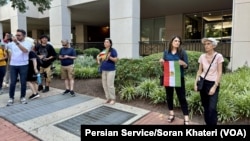 Iranian Americans protest outside Iran’s interests section office in Washington, June 28, 2024, as it hosts an absentee voter ballot station for the first round of the Iranian presidential election.