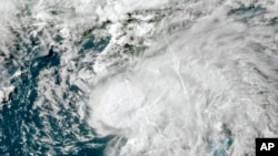 FILE - This satellite image taken July 6, 2021, and provided by NOAA, shows a tropical storm off the coast of Florida. On April 13, 2023, the National Oceanic and Atmospheric Administration said indications were favorable for an El Nino pattern to form in the next six months.