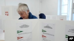 People vote during local elections in Warsaw, Apr. 7, 2024. Voters across Poland voted in local elections Sunday in the first electoral test for the coalition government of Prime Minister Donald Tusk. 