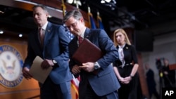 FILE - Speaker of the House Mike Johnson departs a news conference, with Republican colleagues Rep. Blake Moore, left, and Rep. Beth Van Duyne at the Capitol in Washington, Feb. 29, 2024. 