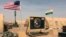 FILE - U.S. and Nigerien flags are raised at Air Base 201 in Agadez, Niger, April 16, 2018. Air Base 201 is one of two bases U.S. troops have used while stationed in Niger.