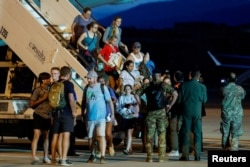 Italian nationals and other European and American citizens who were evacuated from Niger after a junta seized power in the west African country, arrive at Ciampino Airport, near Rome, Italy, Aug. 2, 2023.
