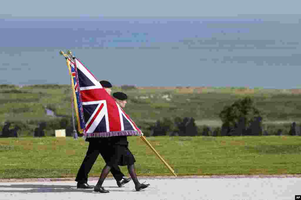 Youth carry the Union Flag during a commemorative ceremony marking the 80th anniversary of the World War II D-Day" Allied landings in Normandy, at the World War II British Normandy Memorial of Ver-sur-Mer, June 6, 2024.&nbsp;