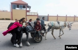 Palestinians fleeing north Gaza after Israeli troops raided Shifa Hospital move southward amid the conflict between Israel and Hamas, in the central Gaza Strip, March 18, 2024.