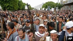 FILE - Houthi supporters chant slogans as they attend a rally marking eight years for a Saudi-led coalition, on March 26, 2023, in Sanaa, Yemen. 