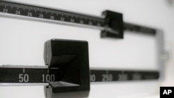 FILE- A close-up of a beam scale is seen in New York, April 3, 2018. 