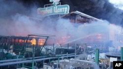 Firefighters put out a fire after two guided bombs hit a large construction supplies store in Kharkiv, Ukraine, May 25, 2024. 