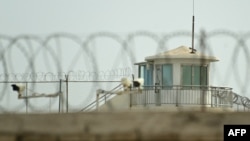 FILE - A watchtower of an alleged detention facility is seen in Artux in Kizilsu Prefecture in China's northwestern Xinjiang region, July 19, 2023.