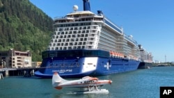 FILE - A floatplane taxis near docked cruise ships as it prepares to take off on July 6, 2023, in the Gastineau Channel, along the downtown waterfront in Juneau, Alaska.
